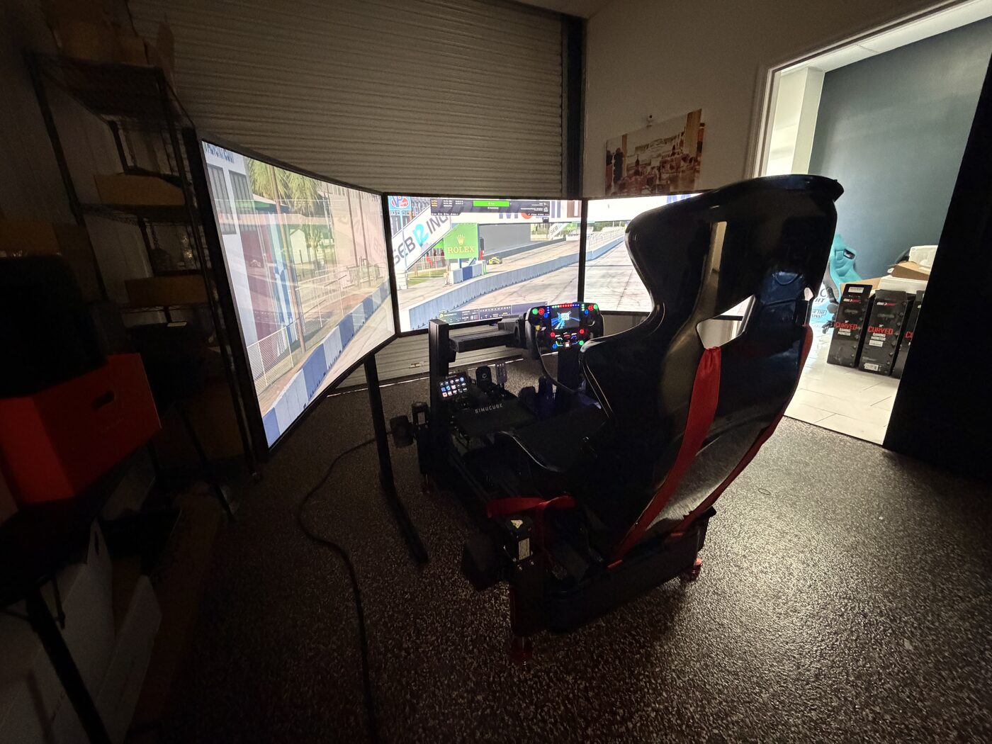 Triple-screen racing simulator in a garage